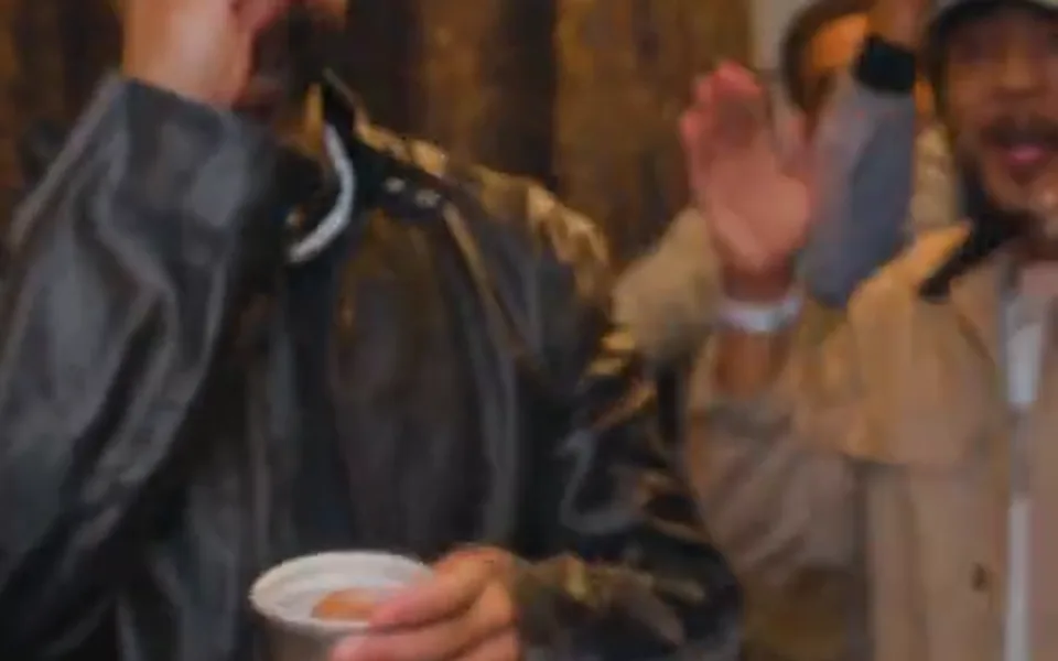 Frame from our Burning Bridges AI demo: the silver cup held low as the song plays.